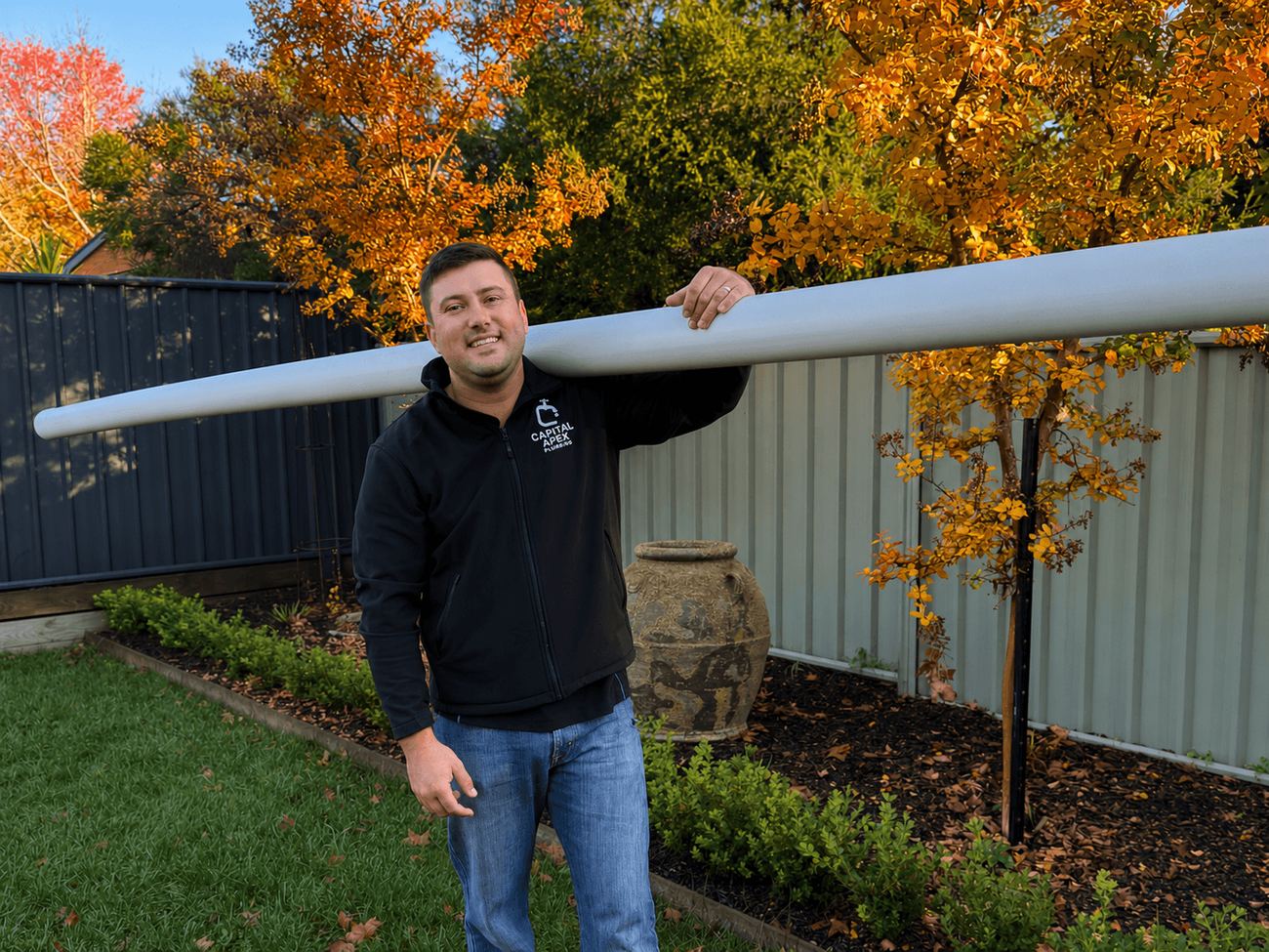 Connor carrying pipe on a job